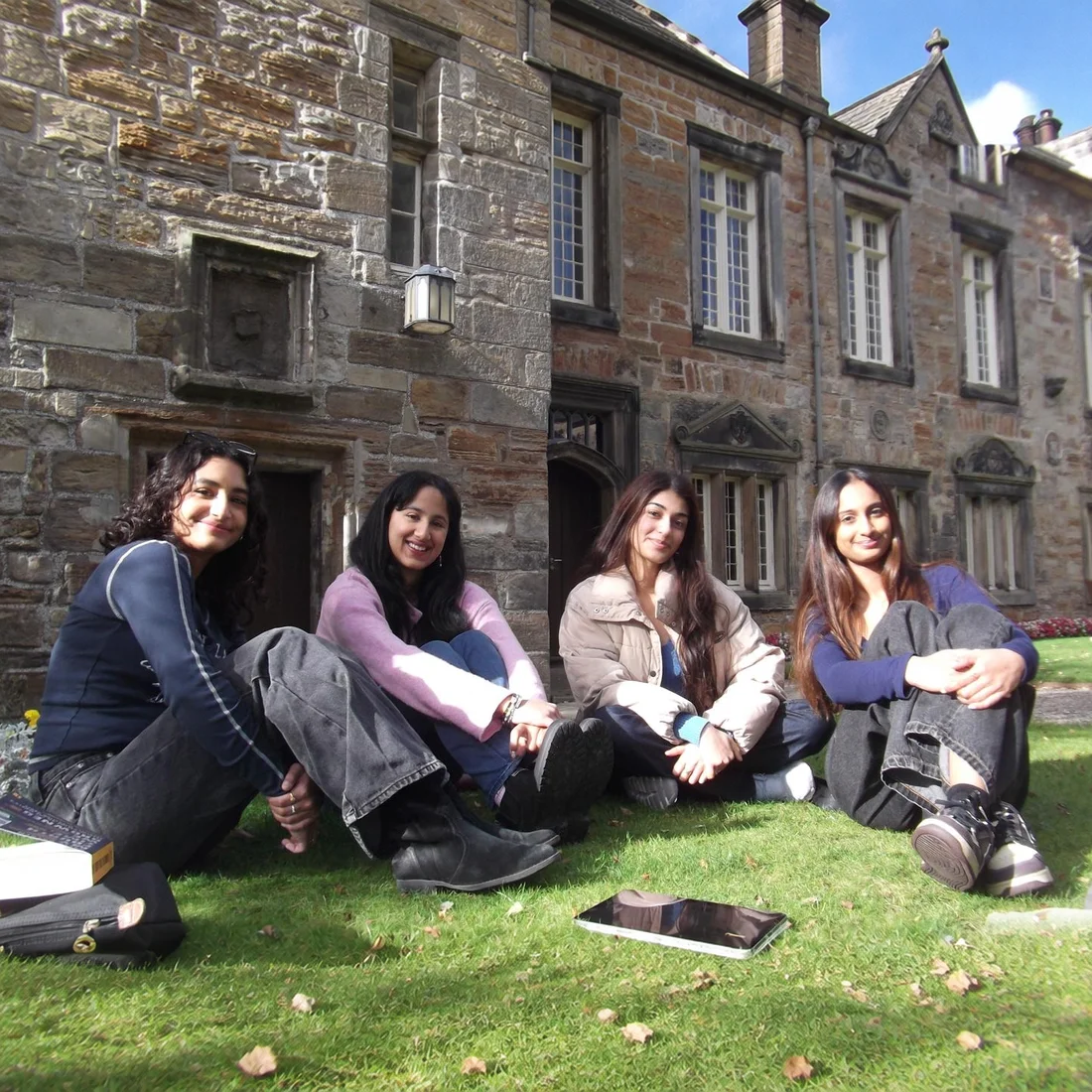 Four readers on the grass at St Mary's Quad after the Readers Table